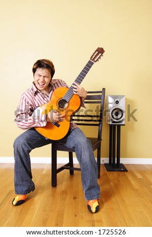 A young man playing guitar