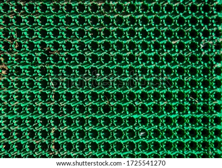 Green plastic grating photo in natural light