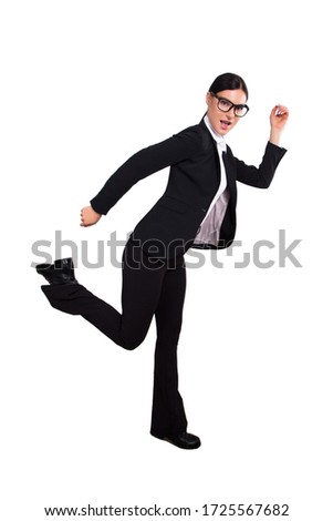 Studio shot of a young businesswoman in a running position isolated on white. Stock Photo