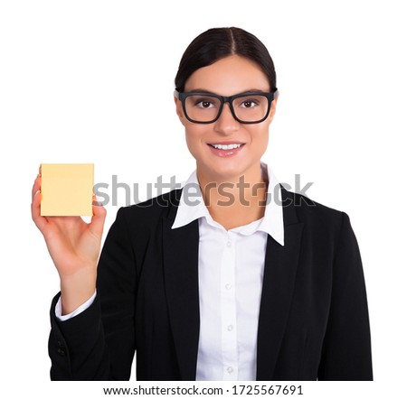 Studio shot of an attractive young businesswoman with a sticky note in her hand. Stock Photo