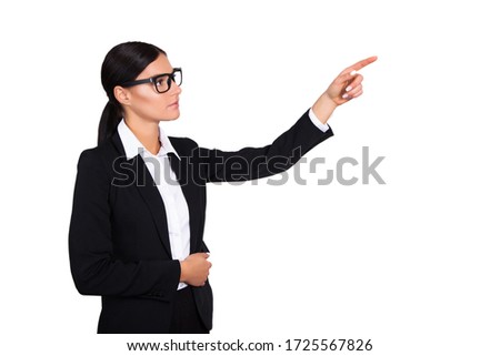 Studio shot of an attractive young businesswoman pointing to copyspace. Stock Photo
