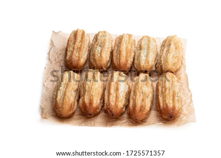 Homemade  baked mini chocolate filled churros isolated on white 