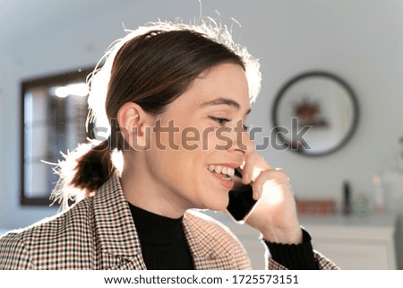 Close up of an attractive young girl talking on the business phone. Telecommuting. 