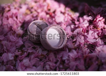 in the pink flower petals is a box for rings