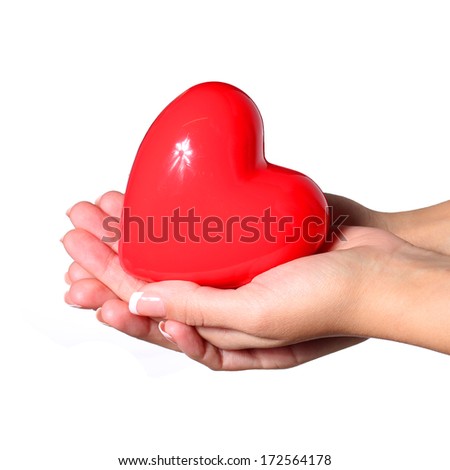 Red heart in female hands, isolated on white background. 