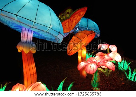 luminous Inflatable Mushrooms, butterfly and flowers on  black background. Chinese street lantern traditional festival