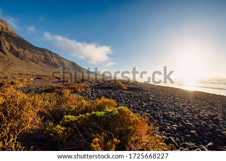 Famara beach, scenic landscape with ocean and mountains in Lanzarote, Canary islands