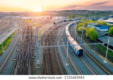 Railway station with wagons during sunrise from above. Reconstructed modern railway infrastructure. Royalty-Free Stock Photo #1725683983
