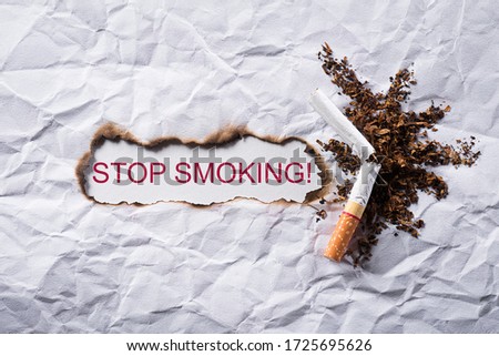 World No Tobacco Day concept, May 31. No smoking sign made with broken cigarettes on white background.