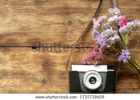 Old retro camera on the abstract background of vintage wooden planks.
vintage color tone