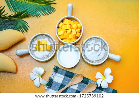 Thai Sago Desserts  with mango ,coconut milk  on yellow background.