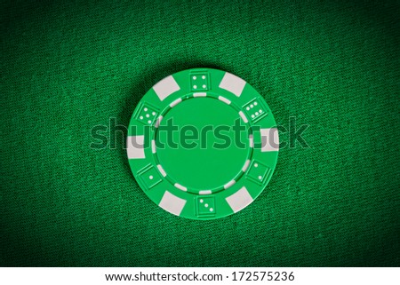 one vignette  macro green poker chip on table
