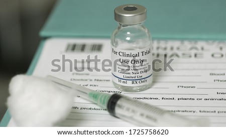 Clinical trial medicine, for the covid-19 coronavirus, on clipboard Royalty-Free Stock Photo #1725758620