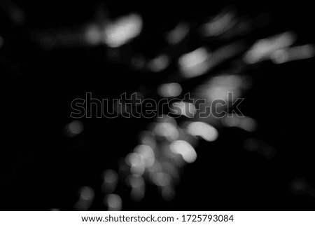 The abstract black and white bokeh of night lighting represents the beauty of the lights that adorn the buildings in the metropolis of brightness.