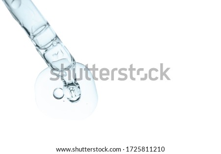 Cosmetic pipette with serum drop swatch of collagen and peptides closeup isolated on white. Liquid dropper with hyaluronic acid, peeling with bubbles. Anti aging woman beauty face product Royalty-Free Stock Photo #1725811210