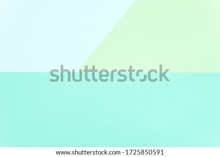 Bright color block paper background: turquoise, light blue and green. Copy space. Space for text. Flat lay, top view. Minimalist. Abstract