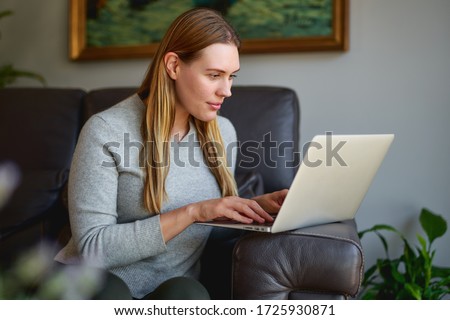 young beautiful woman using a laptop computer at home