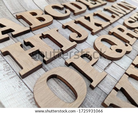 wooden letters alphabetically arranged on gray surface