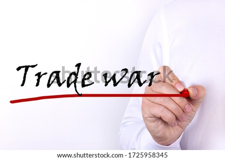 Trade war, text written by businessman hand, marker on a light background. Business concept.