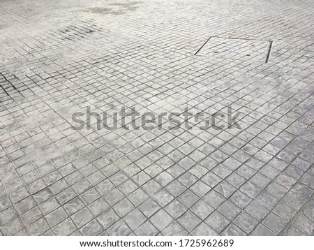 a square floor drain on stamp concrete