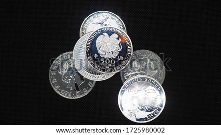 Silver pound ounce oz coins on black background