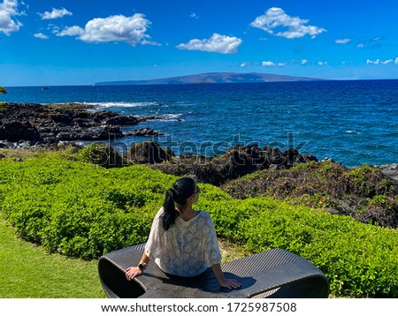 Sitting on the edge of the ocean in Hawaii