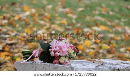 Wedding bouquet on a stone table in the park. Fall. Bouquet of delicate flowers.