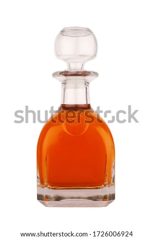 front view closeup of liqueur or whisky glass bottle with large cap and round classical shape isolated on white