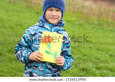 Greating card for the may 9 Victory Day . Children's creativity. Boy demonstrates handmade card.