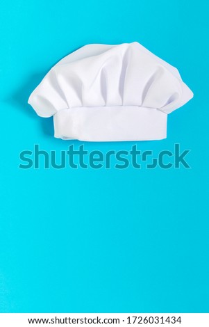 White chef hat on the blue background with copy space. Professional cooking concept Royalty-Free Stock Photo #1726031434