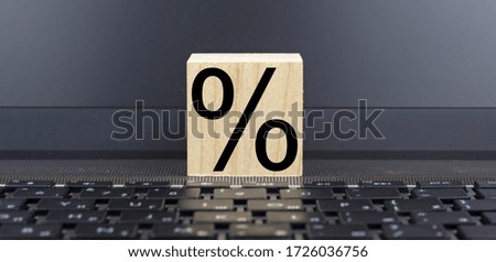 Technology Still life. INTEREST. Wooden block on a computer keyboard.