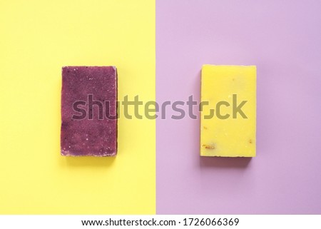 Natural lumpy solid soap.  Yellow and lilac concept. Flat lay composition with fragrant hygiene and body care product. Top view, copy space.