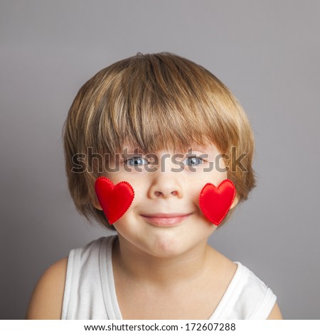 Portrait of a boy with hearts on face