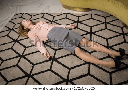 Crime scene with strangled pretty business woman in office

