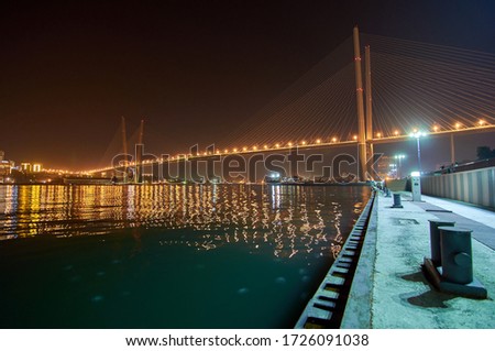 Golden bridge in Vladivostok at night. Night traffic. Tsesarevich embankment. Golden Bridge in sunset, Vladivostok, Russia. 