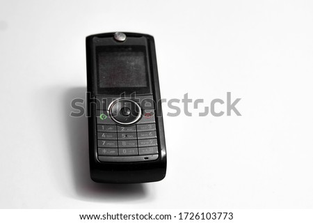 Old mobile phone isolated on white background.