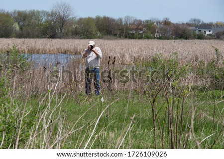 Male photographer taking pictures while enjoying a hike outdoors