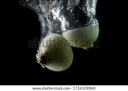onion entering the water and splashing