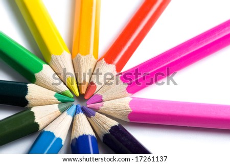 colored pencils in round shape isolated