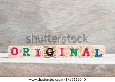 Alphabet letter block in word original on wood background