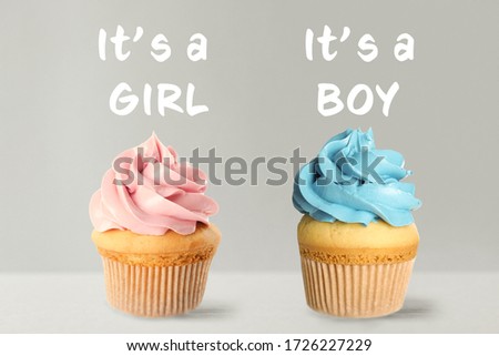 Baby shower cupcakes for boy and girl on light background
