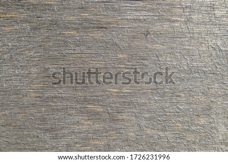 Background texture of dirty grungy plywood board with scratches and cracks.