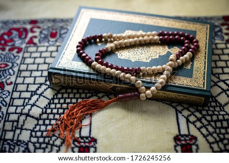 Quran - holy book of Muslims religion, 
Concept: open book holy prayers for god,
Friday month of Ramadan religion Islamic worshiping 
faith and learn koran and rosary, Ramadan Kareem festival concept