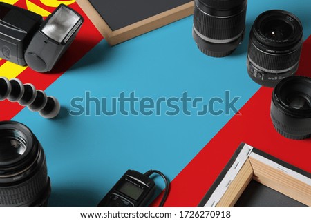 Mongolia national flag with top view of personal photographer equipment and tools on white wooden table, copy space.
