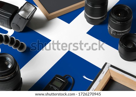 Martinique national flag with top view of personal photographer equipment and tools on white wooden table, copy space.