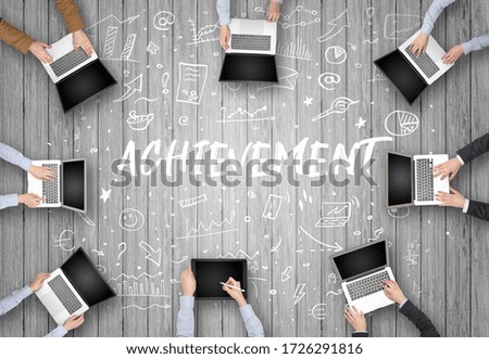 Group of business people working in office with ACHIEVEMENT inscription, coworking concept