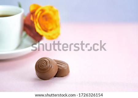 Coffee and rose and chocolate pralines.pink on background