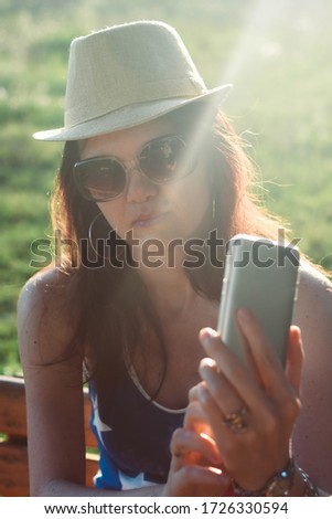 Happy woman make selfie in sunset. Middle aged woman take a selfie with a phone