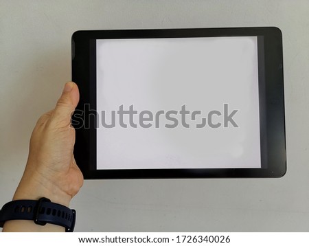 Woman's left hand holding digital tablet for updating news with modern technology, smart life of people. 