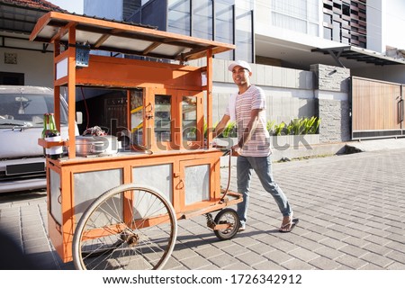 man selling bakso in the carts. indonesia street food. small business entrepreneur Royalty-Free Stock Photo #1726342912
